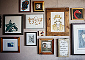 Framed artworks on wall of converted shipping container Bedford, UK