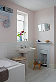 Pedestal washbasin at bathroom window in Colchester family home, Essex, England, UK