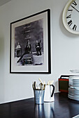 Photographic print with cutlery and plates in kitchen of Colchester family home, Essex, England, UK