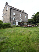 Exterior and back garden of a period home with table and chairs