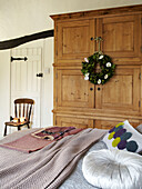 Double bed and wardrobe in bedroom of Herefordshire cottage, England, UK