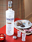 Christmas biscuits and alcohol on red table in Polish home