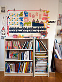 Bookcase storage and artwork in child's room of French family home