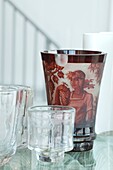 Five vases on glass table still life