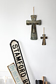 Two religious crosses and road signs in Reigate home, Surrey, UK