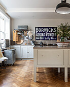 Vintage sign and kitchenware with original parquet flooring in Woodbridge kitchen, Suffolk, UK