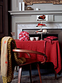 Dining room table with tea set and cake stand in front of fireplace