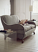 White washed living room with sofa half upholstered