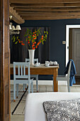 Cut flowers on wooden table in beamed Hastings cottage