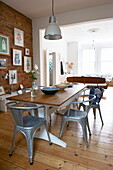 Dining room with exposed brick wall in Broadstairs home, Kent, England, UK