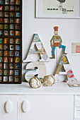 Carved letter 'A's on sideboard in Broadstairs home, Kent, England, UK