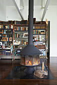 Freestanding fireplace and bookcase in open plan Sheffield home, Berkshire County, Massachusetts, United States