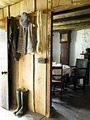 Clothing and wellington boots in farmhouse porch
