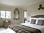 Neutral bedroom with propeller above bed