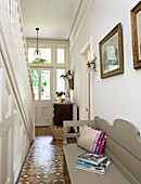Original tiling and gilt framed pictures in hallway of Hereford home, England, UK