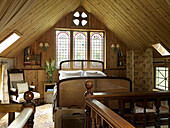 Wicker bed below stained glass window in Shropshire chapel conversion England, UK