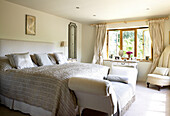 Daybed in neutral bedroom with open windows Somerset new build in rural England UK