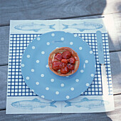 Strawberry tart on a blue spotty plate