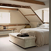 Small beamed attic bedroom with eaves and a double bed