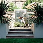 Wooden steps leading to contemporary decked garden room