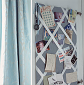 Homemade pin board showing letters and postcards hung inside a cupboard door