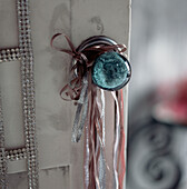 Ribbons hanging on a coloured glass door knob
