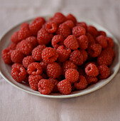 Plate of fresh ripe red raspberries