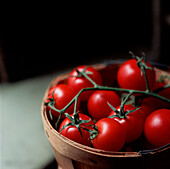 Wooden bowl of fresh ripe vine tomatoes