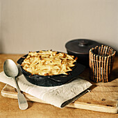Savory baked potato dish on a wooden chopping board