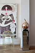 Artwork with birdcage and mirrored ornaments in contemporary London home England UK