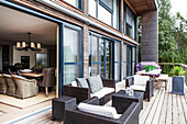 Outdoor furniture on terrace decking of lakeside home, England, UK
