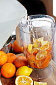 Adding water to oranges for marmalade in Southend-on-sea, Essex, England, UK