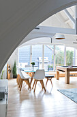 Glass topped dining table and chairs with bench seat in converted London courthouse UK