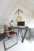 Brown leather chair at desk in converted London courthouse London UK