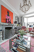 PInk hues and artwork in living room of Victorian terrace Wandsworth London Uk