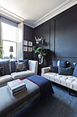 Dark panelling and blue hues in drawing room of Victorian terrace Wandsworth London Uk