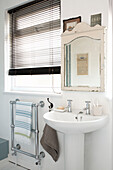 Pedestal washbasin and wall mounted towel rail in Isle of White bathroom