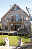 Wooden building exterior with decking and lawn in Gurnard Isle of White