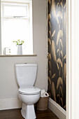 Black and gold wallpaper in bathroom detail of London home England UK