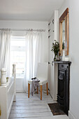 Victorian fireplace and window detail in bedroom of Weymouth home, Dorset, UK