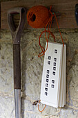 Gardening string and spade hang in shed, St Lawrence, Isle of Wight, UK