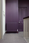 Muted purple paintwork on carpeted landing of contemporary Bristol home, England, UK