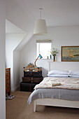 Vintage suitcases stacked at bedside in Bembridge home, Isle of Wight, UK