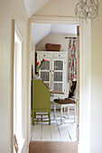 View through doorway to lime green writing desk in East Cowes home, Isle of Wight, UK