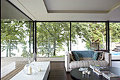 Full length windows in seating area with view to the solent from modern Isle of Wight home UK
