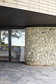 View into basement bedroom through windows in pebble-dashed lower storey Isle of Wight, UK