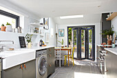 Industrial-style kitchen renovation with leather fittings and garden access London UK