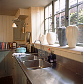 Stainless steel worktop and ceramics in kitchen