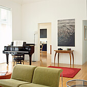 Offener moderner Wohnbereich mit 60er-Jahre-Möbeln und Flügel