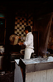 Chinese man cooking noodles in a street market in Shanghai China